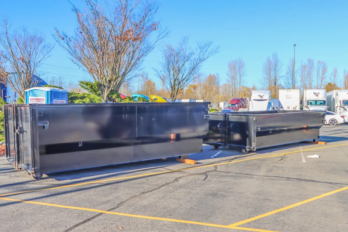Professional dumpster rental service with roll-off container on residential driveway in Quantico Base